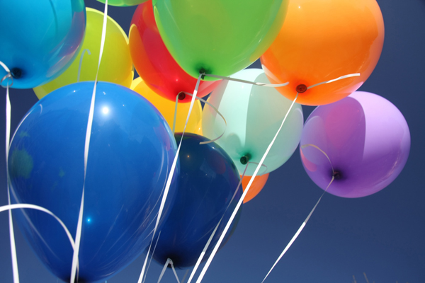 colourful balloons set against a blue sky