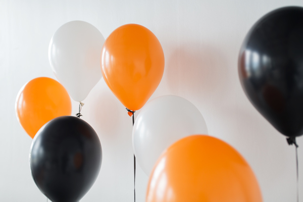 range black and white latex balloons in a white room